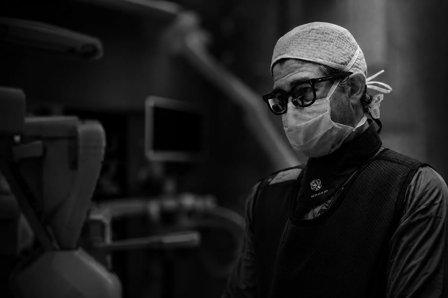Dr. Rod Oskouian in the operating room, in surgical cap, mask and loupes